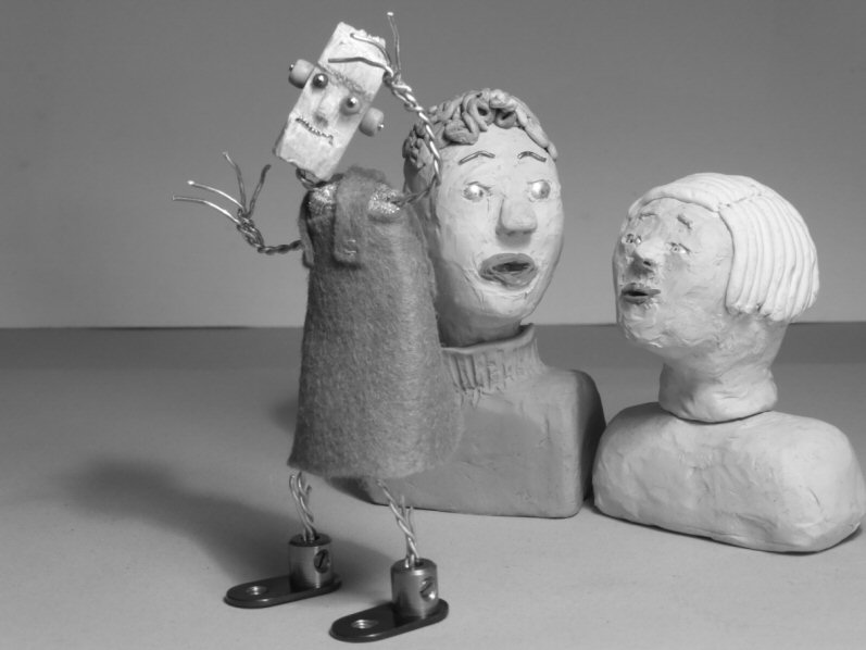 two plasticine heads and standing wire puppet