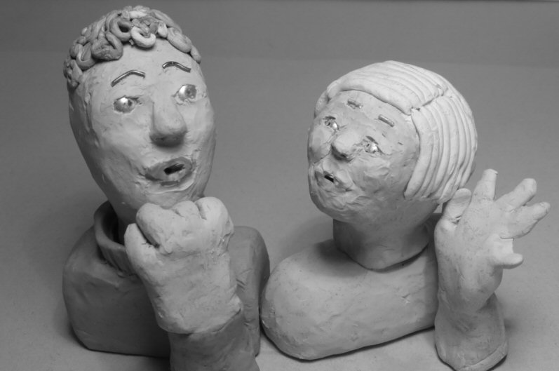 two plasticine heads looking at each other