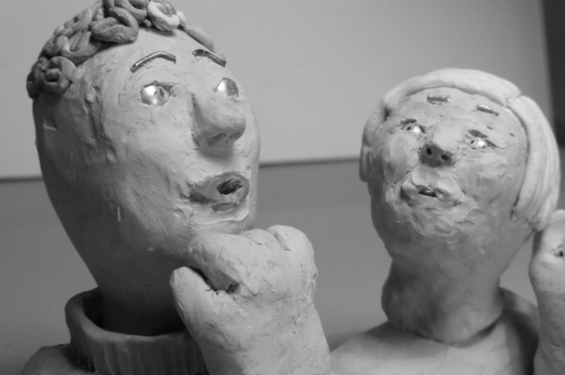 two plasticine heads three quarter view