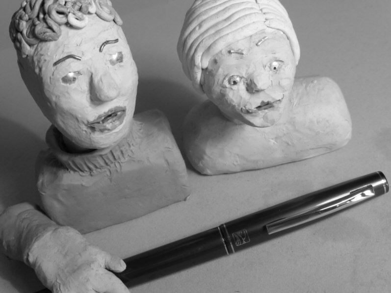 two plasticine heads and pen