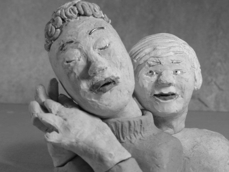 two plasticine heads: one asleep