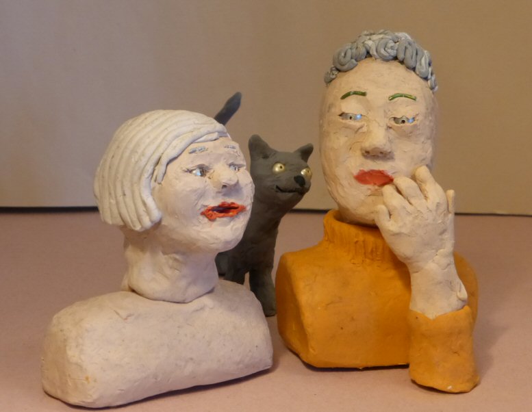 two plasticine heads and plasticine cat