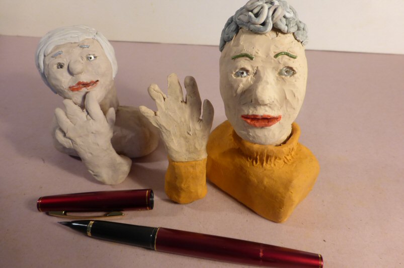2 plasticine heads and a pen